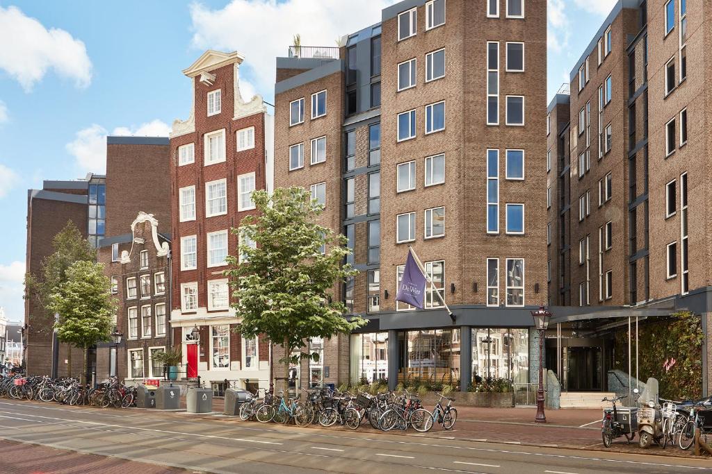 Joined brick facades of differing heights along a canal street